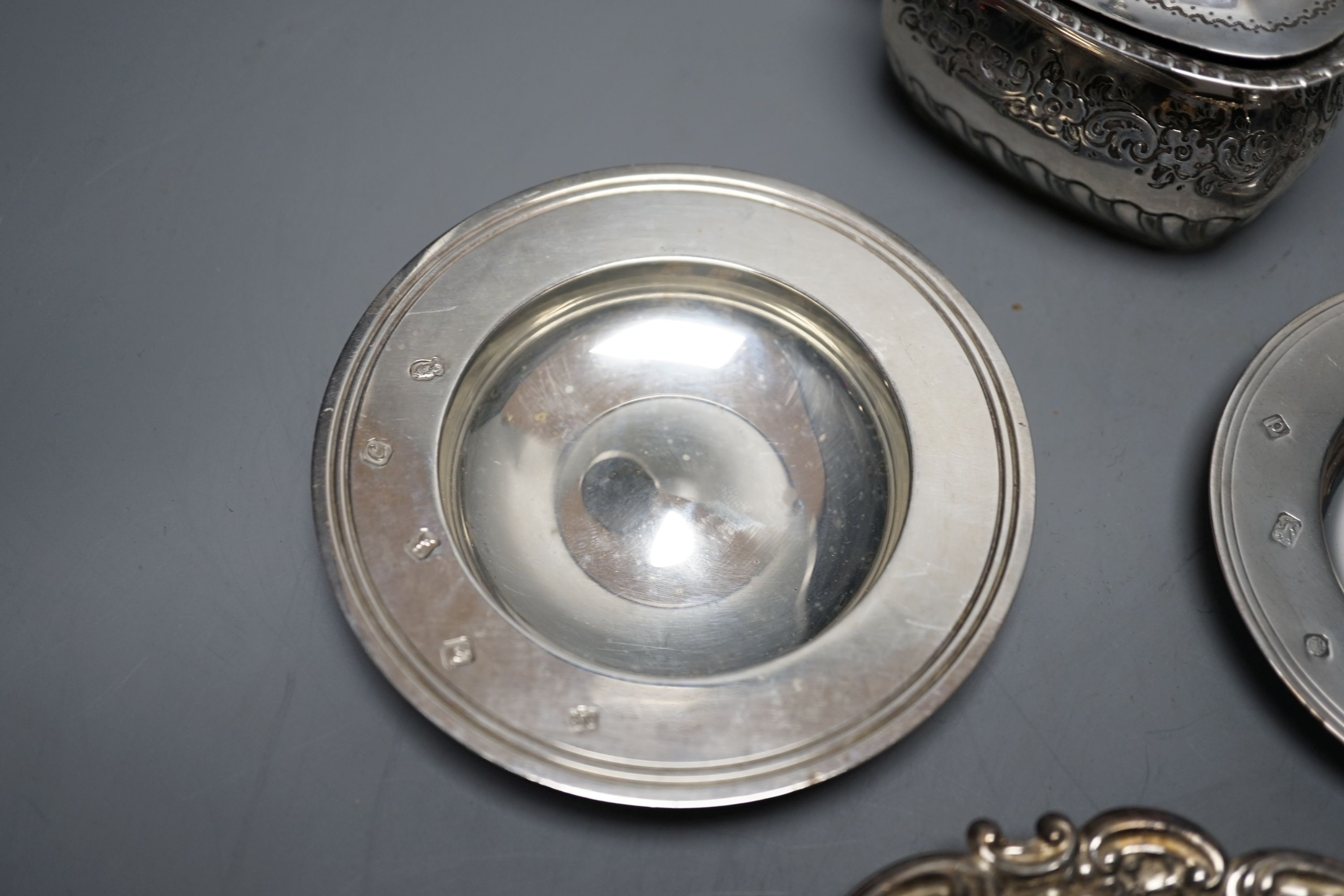 A late Victorian silver mustard, Sheffield, 1895, two small silver armada dishes, a silver bonbon dish, silver tea strainer(a.f.) and a silver mounted glass toilet jar.